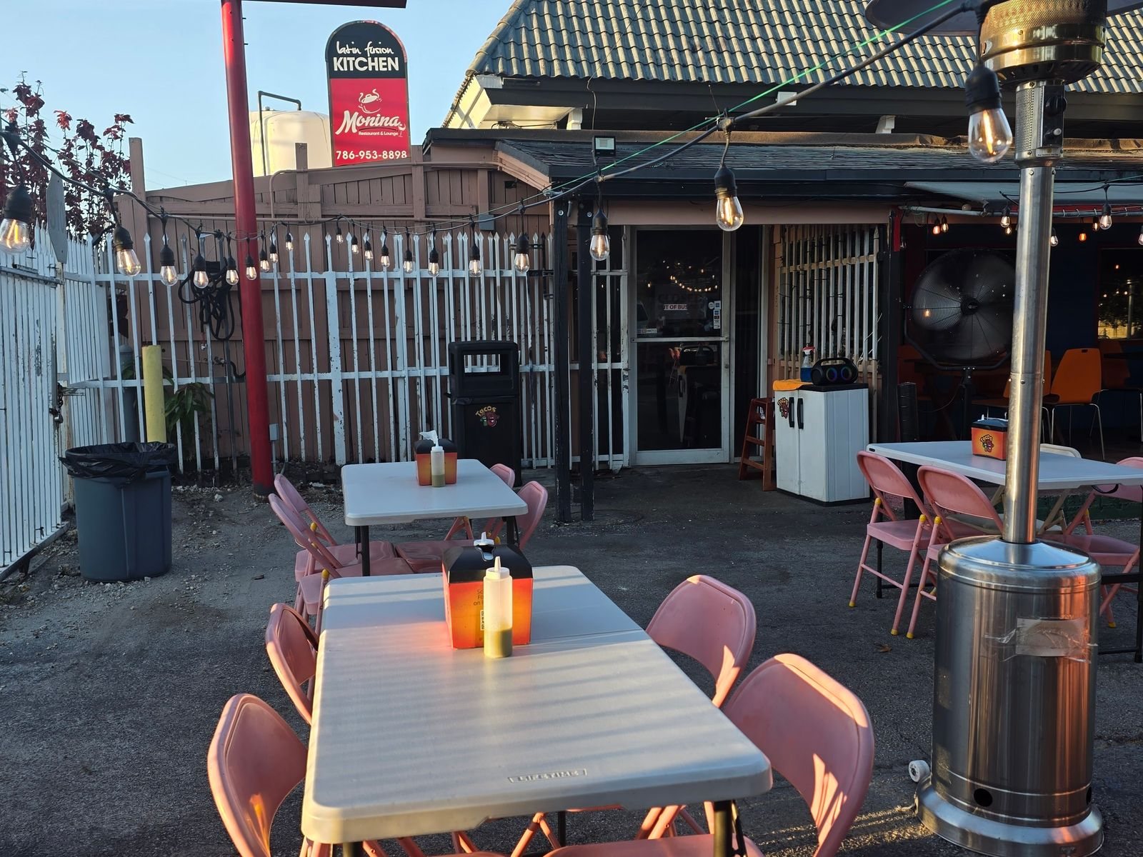Tacos 19 outdoor seating with pink chairs and string lights
